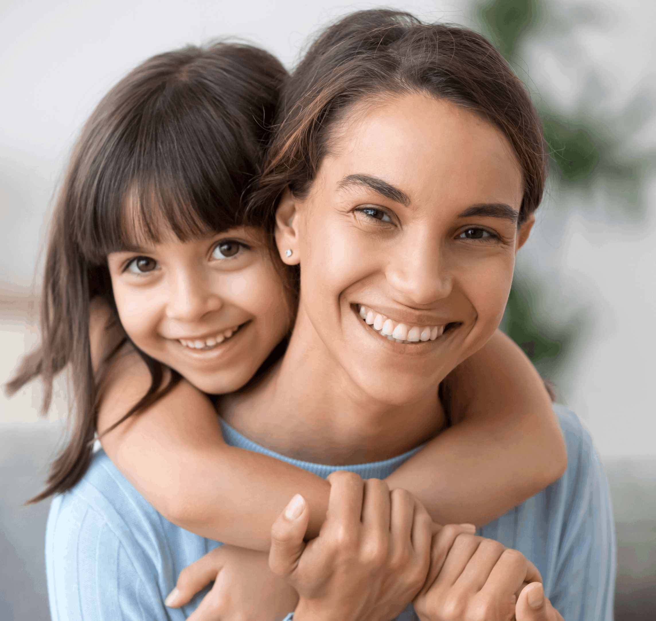 Mother and daughter embracing and smiling